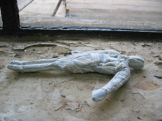 A small cloth human figure, made from fabric cut from a street mattress. 2004