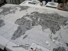 'Letters from the bank' a map of the world made from letters from the bank, cut rolled and glued into bead forms, then woven together using a beading technique.