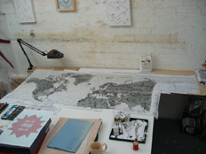 work table showing 'Letters from the bank' and red embroidery on graph paper